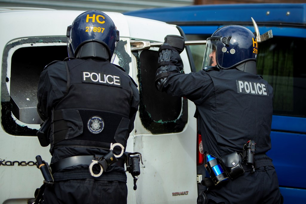 Officers forcing entry to a vehicle